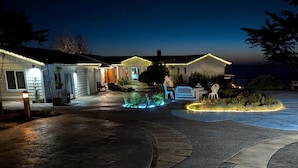 A residential property with a driveway leading to a house, outdoor seating area, and decorative lighting. - Sparkling Clean, Private & Quiet! Amazing Ocean Views [3] (Brookings)