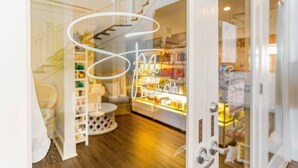 A glass door with a sign reading "Spa at the Bench Club" and a glimpse of a bar area with shelves and bottles.