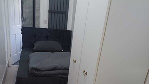 A bedroom with a bed, a wardrobe, and a bathroom visible through an open door. - Budgeted Shared Residence near Coventry Building Society (CBS) Ricoh Arena & M6 (Coventry)