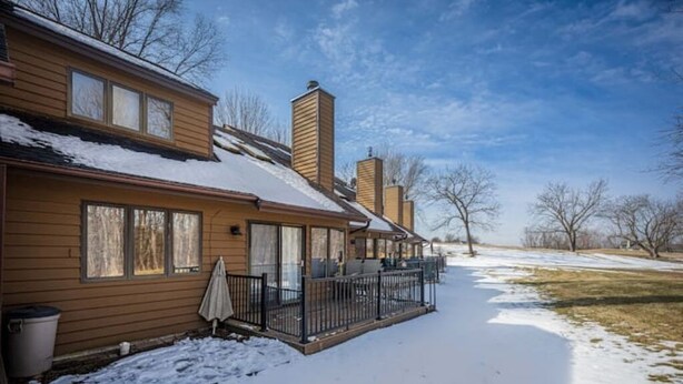 A two-story house with a covered porch and a snow-covered yard. - The Galena Getaway  Townhouse in Galena Territory (Galena)