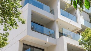 A multi-story building with balconies and large windows. - Cubes Living Athens, Studio 302 (Athina)