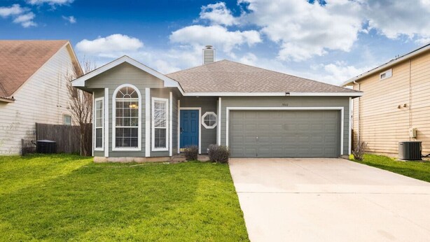 A single-story house with a grey garage door, a blue door, and a small front yard. - Super Clean/ Fun Environment! Low Cleaning Fee! (Georgetown)