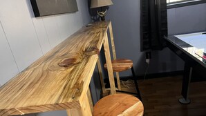 A wooden bar with two stools, a lamp, and a window with curtains. - Dragons Lair - motorcycle friendly, all paved roads, lockable garage, no incline (Robbinsville)