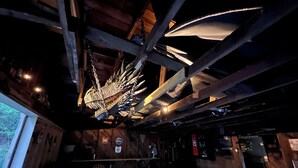 A room with a wooden ceiling, a large chandelier, and a checkered floor. - Dragons Lair - motorcycle friendly, all paved roads, lockable garage, no incline (Robbinsville)