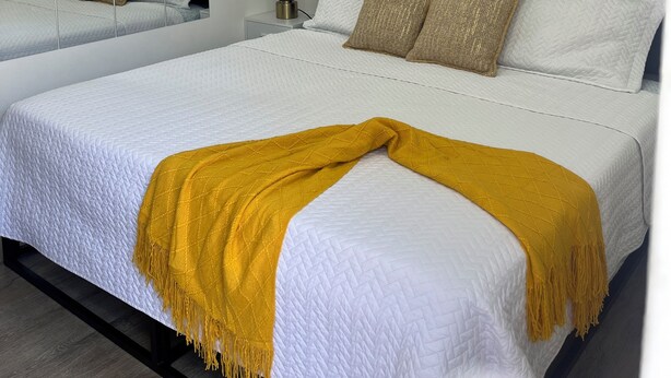 A modern hotel room with two beds, white bedding, and a yellow throw blanket. - Cozy Private Entire Studio Suite Independent Guest Entrance (Jacksonville)