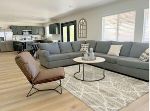 Relax in this stylish living space with a sofa, armchair, and coffee table, plus a fully equipped kitchen area.
