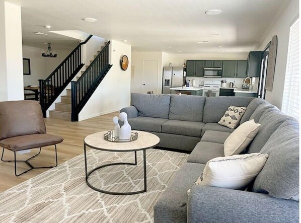 Relax in the living room with a comfortable sofa and armchair, perfect for unwinding after a day out.