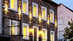 A multi-story building with stone facade and multiple windows, featuring a staircase and a gated entrance. - MoselVilla No 7 (Pommern)