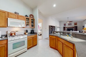Enjoy cooking in this well-lit kitchen with a central island, oven, and stovetop.