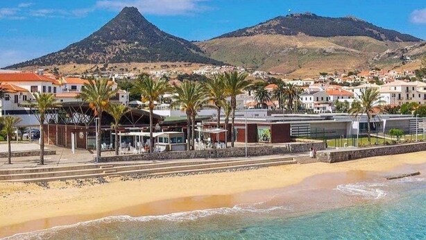 A coastal town with a beach, palm trees, and a mountain in the background. - SandybeachApartment2 in the Golden Island  (Vila Baleira)