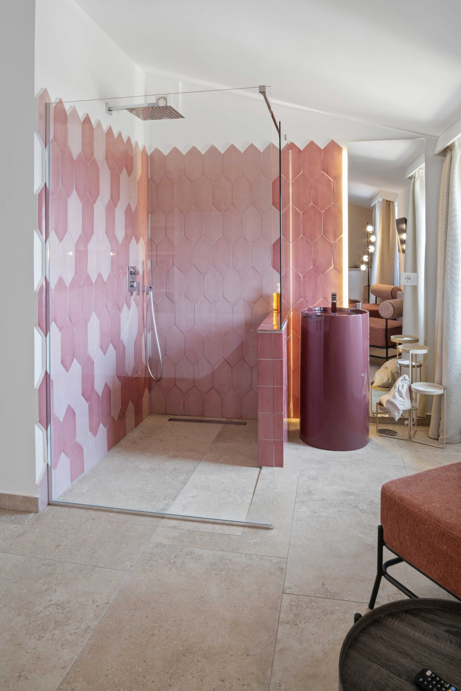 A modern bathroom with a shower area, a vanity with a mirror, and a seating area with a table and chairs.