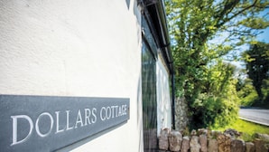 A sign reading "DOLLARS COTTAGE" on a building's exterior wall. - Dollars Cottage - 4 Bed - Llangennith (Swansea)