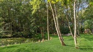 A lush green landscape with tall trees and a grassy area. - Awesome home in Nykøbing M (Nykøbing M)
