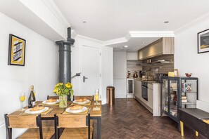 Enjoy a cozy breakfast for two in this compact living space with a dining area and kitchenette, perfect for self-catering.
