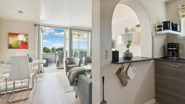 A modern interior with a dining area, kitchen, and a view of the sea. - Pet friendly apartment in Allinge (Allinge)