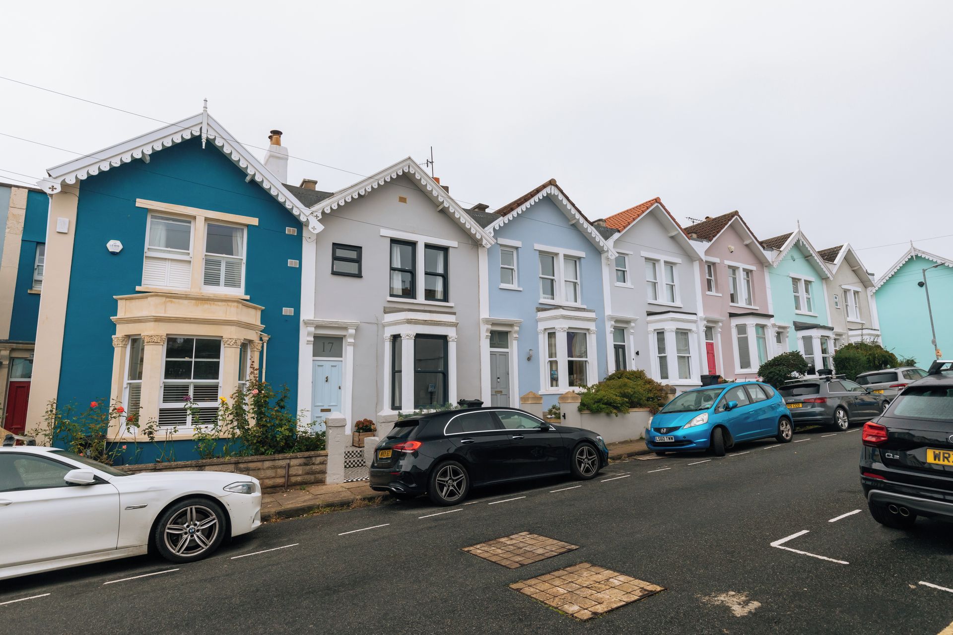 A row of terraced houses with a street in front.