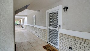 A covered walkway with a tiled floor, a metal gate, and a welcome mat. - Hot Springs Retreat w/ Fireplace on Lake! (Hot Springs)