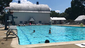A swimming pool with lounge chairs and a lifeguard stand. - Gorgeous model single family home, fully renovated and ready for you.  (Newport News)