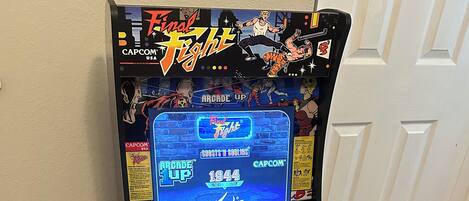 A vintage arcade machine, Final Fight 1944, with a joystick and buttons labeled 'ATTACK', 'JUMP', and 'ATTACK'.