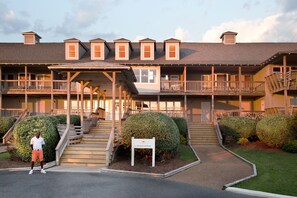 Stunning Beach House with a central entrance and beautifully manicured lawn.