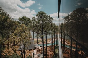 A view of a resort area with a pool, trees, and a clear sky. - Get Hotel Molvento, AKEN SOUL Collection (Villa General Belgrano)