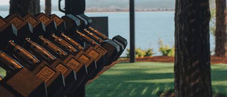A gym with weightlifting equipment and a view of a lake.
