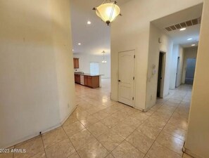 Stylish hallway leads to a well-equipped kitchen area with ample space for meal preparation.