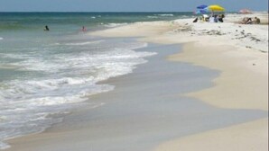 A beach with people, a sandy shore, and a clear sky. - Sublime Sunset☀️ Ocean Front Getaway (Port St. Joe)