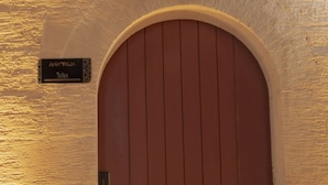 A door with a sign above it that reads "ANA'TALIA Tufan." - Ana Talia House (Mardin)