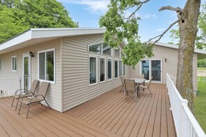 A single-story mobile home with a deck, two windows, and a door. - Amazing Grace Etta Shores (Henning)