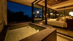 A modern bedroom with a large bed, a glass-enclosed jacuzzi, and a view of the night sky. - GOTO RETREAT by Onko Chishin (Goto)