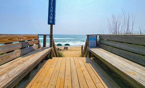 A wooden boardwalk leading to a beach with benches and a sign that reads "SEAHAWK". - Banks Websight - Just a 3 minute walk from the OBX beach, your perfect vacation home awaits! (Duck)