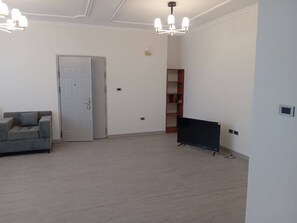 Relax in this open-plan living space with a comfortable sofa and flat-screen TV.