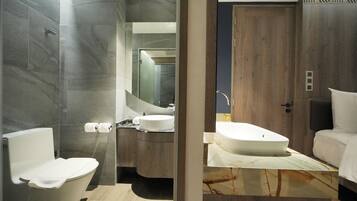 A modern bathroom with a toilet, sink, and mirror.