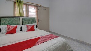 A bedroom with a bed, a wardrobe, and a window with curtains. - OYO 92833 Penginapan Syariah (Pekanbaru)