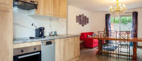 A modern kitchen with wooden cabinets, a built-in dishwasher, and a coffee maker.