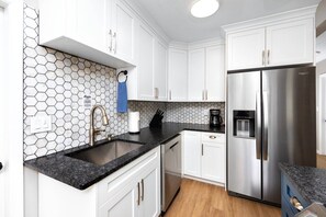 Updated Kitchen with Stainless Steel Appliances and Sleek White Cabinets