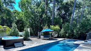 A rectangular swimming pool with a tiled deck, surrounded by lush greenery and trees. - Santa Rosa Beach|Heated Pool|Pet Friendly|Hot Tub|Boat Parking (Santa Rosa Beach)