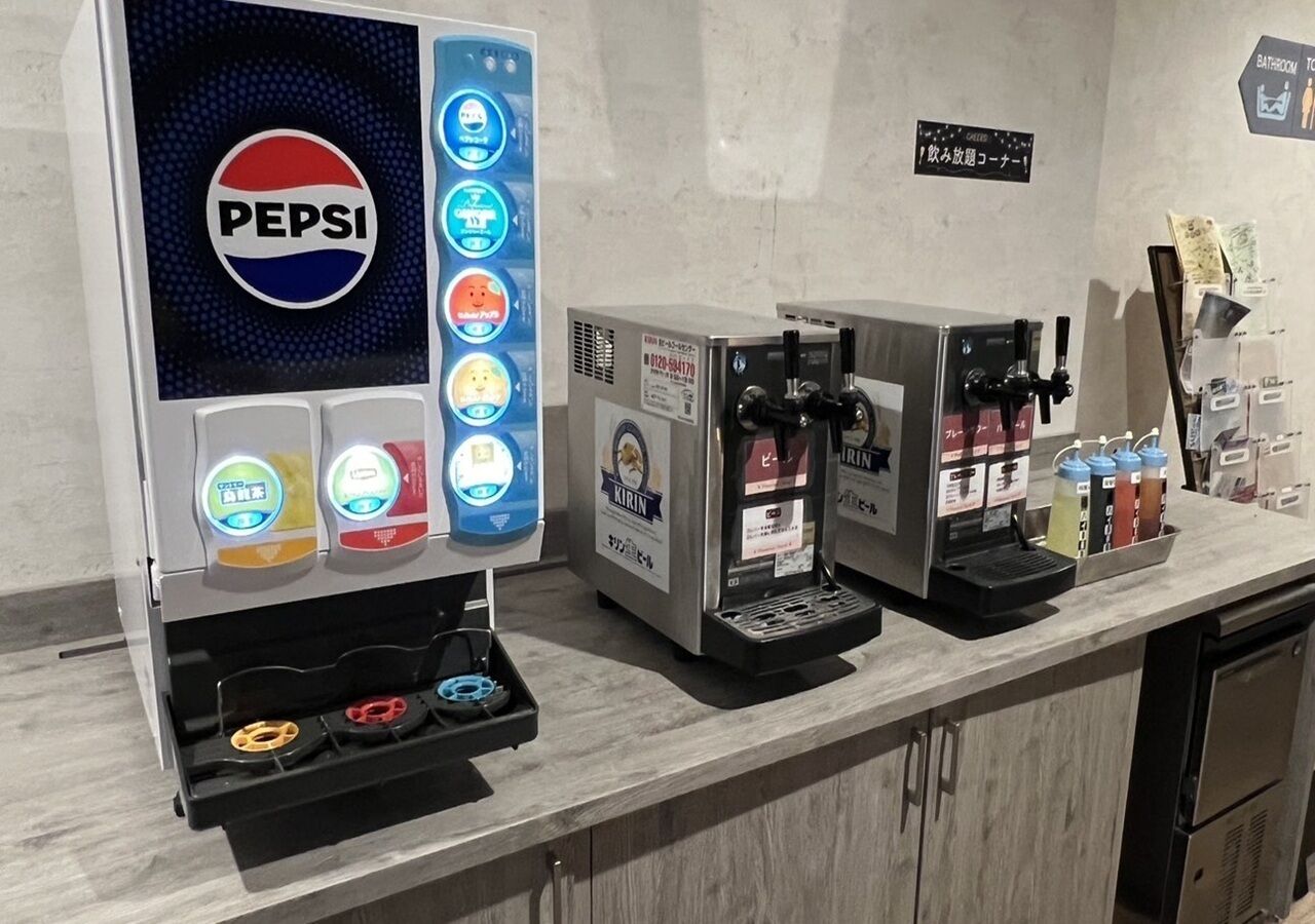 A beverage station with a Pepsi machine and a Kirin beer dispenser.