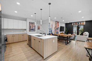 Enjoy cooking in this well-lit kitchen with a central island, sink, and ample counter space.