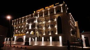 A multi-story building with the sign "LYNATEL PALACE" illuminated at the top. - Lynatel Palace (Ouargla)