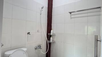 A small, compact bathroom with a toilet, shower, and a metal towel rack.