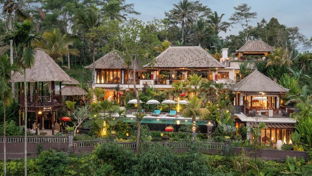A resort with multiple buildings, a swimming pool, and lush tropical vegetation. - Villa Lembah Damai (Taro)