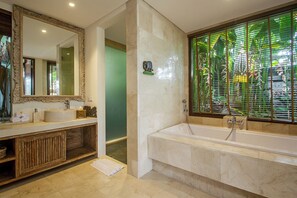 Suite with Balcony | Bathroom | Rainfall showerhead, free toiletries, hair dryer, slippers