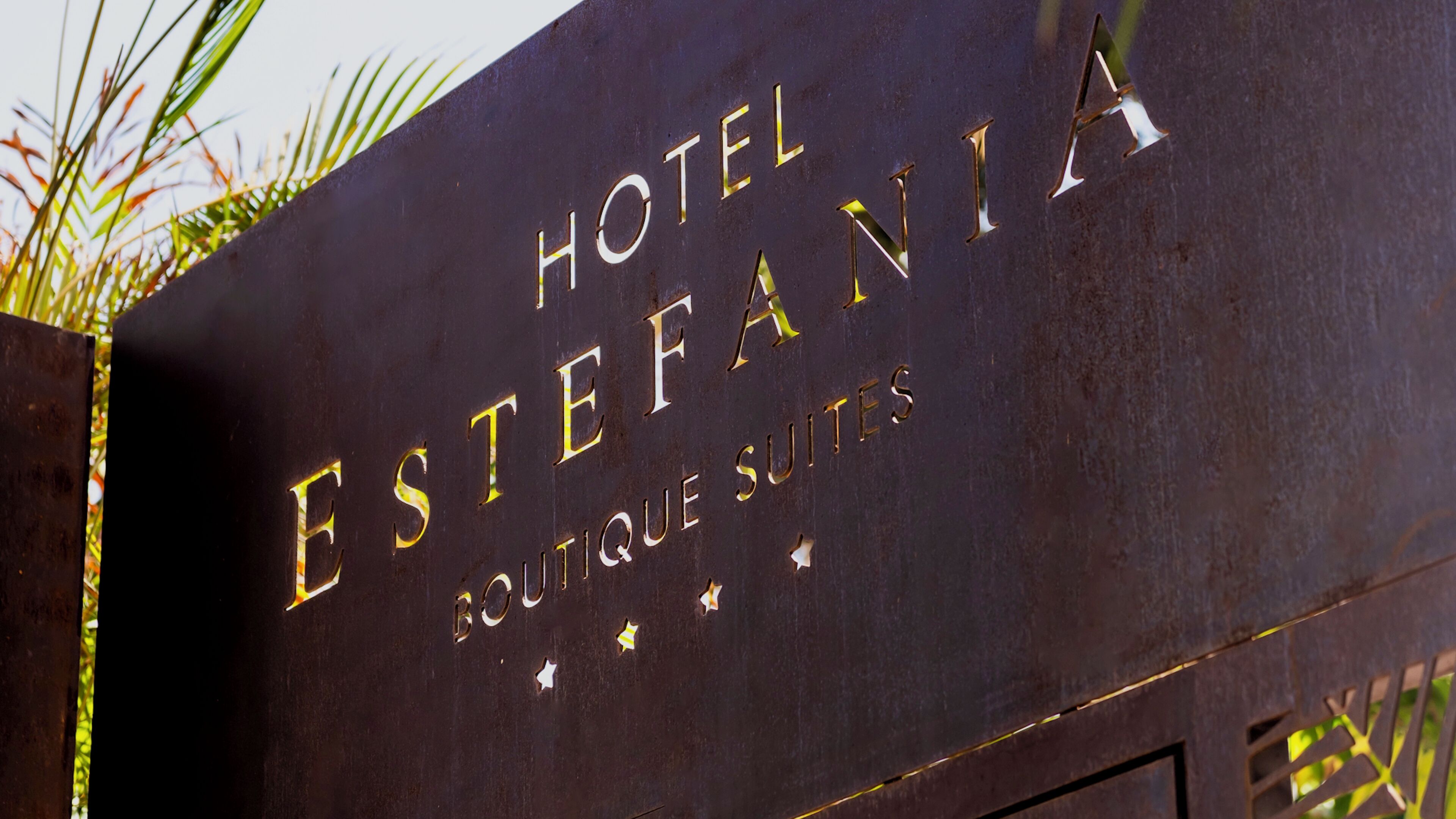 A sign for Hotel Estefania with the text "HOTEL ESTEFANIA" and "BOUTIQUE SUITES" visible.
