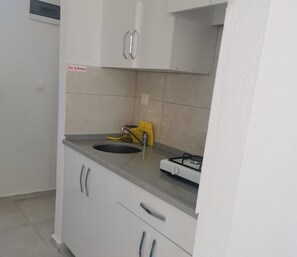 Mini-fridge, cleaning supplies, paper towels