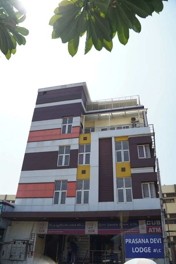A multi-story building with a mix of commercial and residential units. - Prasanna Devi Lodge (Tiruchirappalli)
