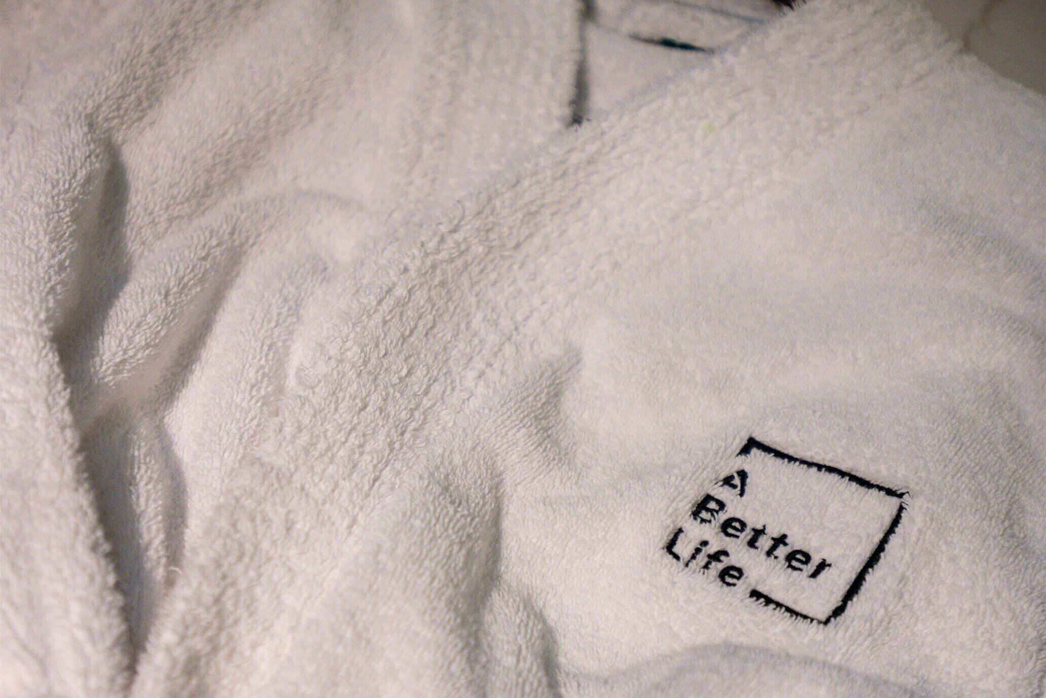 A white towel with a patch that reads "Better Life."