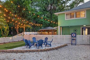 A patio area with outdoor seating and string lights.