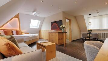 Deluxe Suite | Living area | 45-inch flat-screen TV with cable channels